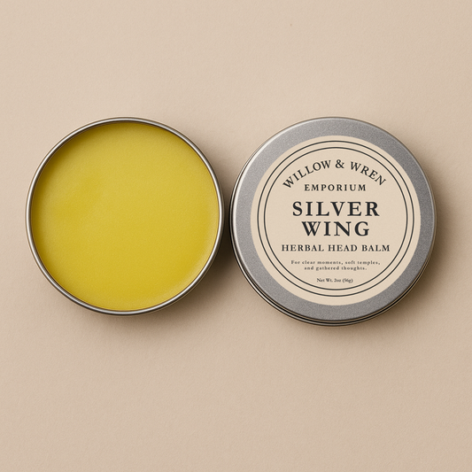 Yellow herbal head balm in a tin with 'Willow & Wren' label on a beige background