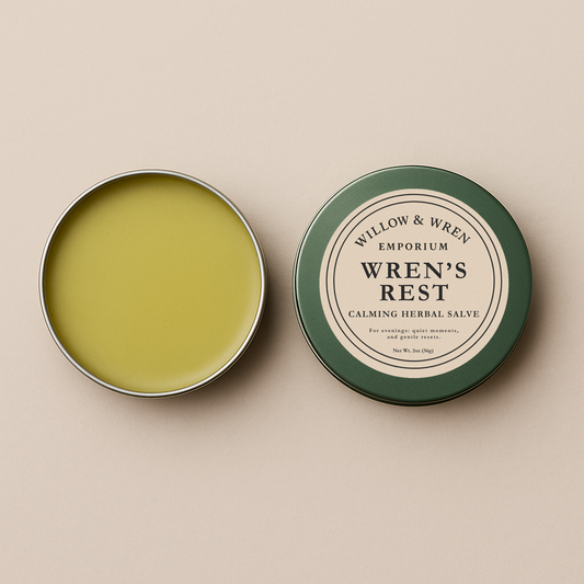 Open tin of Wren's Rest salve with label on a beige background